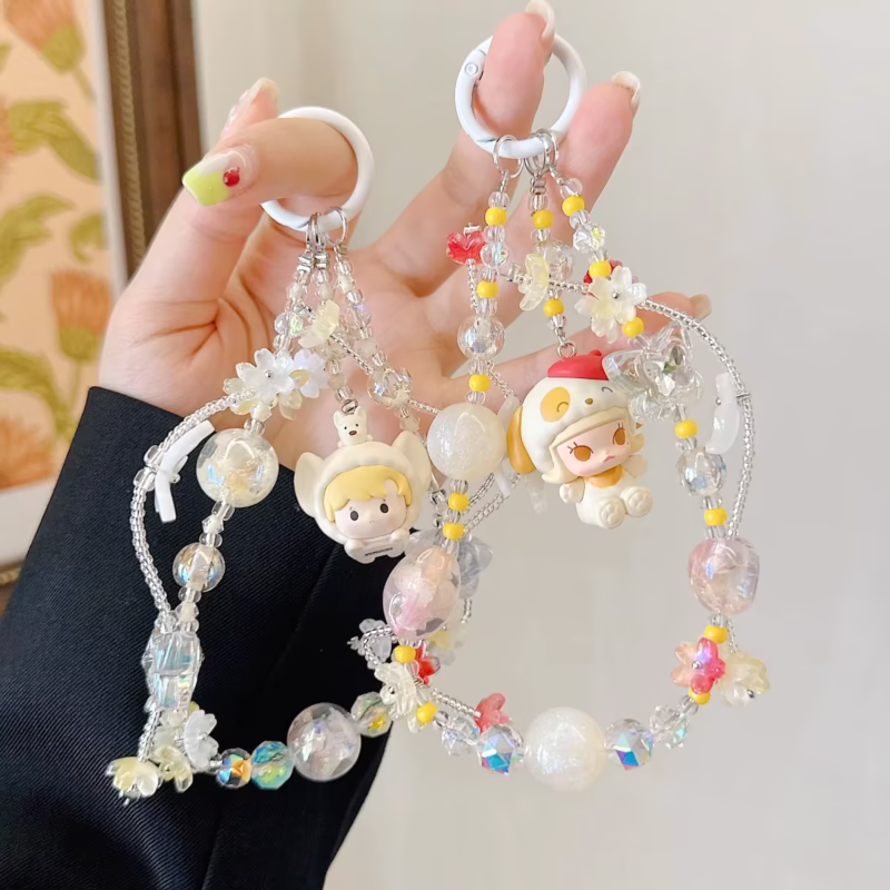 With blurs of colors like blushing rose and warm sunshine, the Dimoo Cry Baby Pajama Party Series phone chain clockwise